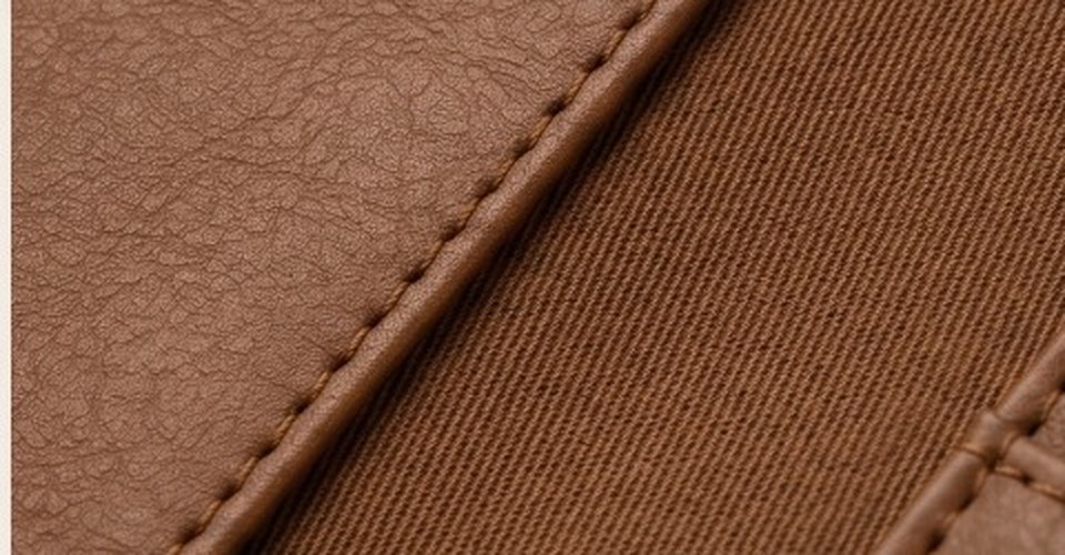 Macro view of saddle-stitching at the wallet's edge